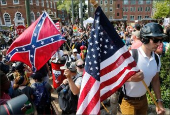 Surrounded by counterdemonstrators, white nationalist demonstrators walk into Lee Park in Charlottesville, Va., on Aug. 12.