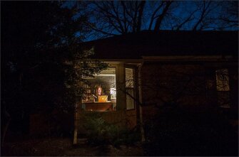 After her children have gone to bed, Sara Doolittle takes advantage of quiet time to work on a research paper in her home office.