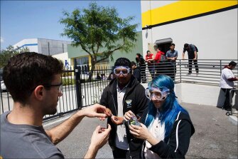 Alberto Esparza and Valerie Flores, right, prepare a lab experiment with teacher Matt Duda, left, during chemistry class.