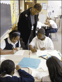 State education consultant Diana Wilson checks in on her voucher students at St. Francis School in Cleveland on March 15.