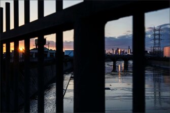 Just a few miles north of the Alliance Collins Family College-Ready High School, the skyline of downtown Los Angeles stands at sunset as seen from a bridge overlooking the Los Angeles River.