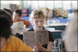 Brienna Kollock, a 2nd grader, reads at her desk at Lulu M. Ross Elementary School in Milford Del., where students' test scores are closely monitored to identify academic needs.