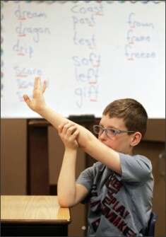 Jayden Jacobsen raises his hand during a lesson at Freeman Elementary School in Freeman, S.D. The state is implementing the Common Core State Standards this year in English/language arts and mathematics. The common core has prompted fierce debate in state legislatures and is the topic of legislation in Congress.