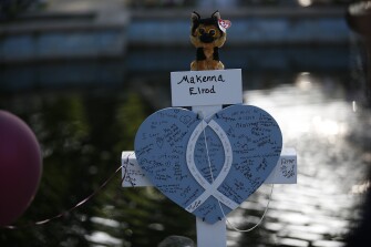 Makenna Elrod's cross stands at a memorial site for the victims killed in this week's shooting at Robb Elementary School in Uvalde, Texas, Friday, May 27, 2022.