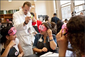 As part of a National Lab Day project, Chemical Engineering Professor Benjamin Davis of The Cooper Union Albert Nerken School of Engineering works on a chemical experiment with students at the East Side Community High School in New York.