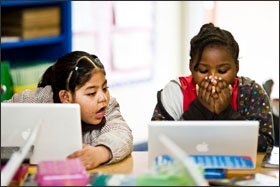 Second graders Lizet Onofre, left, and Dasia Hunt collaborate while studying math using an online program called Reasoning Mind in an after-school program at Mayo Elementary School in Compton, Calif.