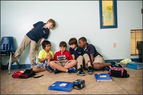 Mater Beach Academy 3rd graders, from left, Gabriel Galan, Jason Salduende-Munoz, Thomas Valenziano, Sebastian Orozco, and Kevin Guette, play a video game at the Miami Beach, Fla., school. In 2010, the academy switched from being a Catholic to a charter school.