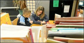Teacher Stacy Veiseth helps 3rd grader Brandon Van Wyk improve his decoding skills during reading time at Lynnville-Sully Elementary.