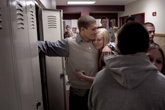 Mr. Davis hugs his girlfriend, Alye Wagner, 14, between classes at Cheyenne Central High. A re-entry specialist from the school district works with the detention facility, the school, and the justice system to ease students back into school.