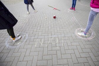 Schoolgirls observe the rules of social distancing on the playground of the Goldbeck School in Hamburg, Germany, Monday, May 4, 2020.