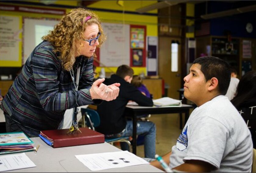 Teacher Meredith Vanden Berg works with Jose Virgen, an English-learner in her 8th grade science class in Beaverton, Ore. She has been working with other teachers in her school to develop strategies for helping English-learners master the common core.