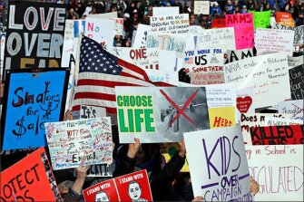 Crowds of people hold signs on Pennsylvania Avenue at the "March for Our Lives" rally on March 24 in Washington.