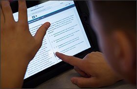 A seventh-grade student at Marshall Simonds Middle School navigates a practice PARCC test on an iPad before field testing last March at the school in Burlington, Mass. Massachusetts is allowing its districts to decide whether to use the PARCC tests this year or stick with the previous state test, the MCAS.