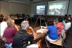 In a nearby classroom, teachers and researchers observe students via video camera during the Elementary Mathematics Laboratory at the University of Michigan.