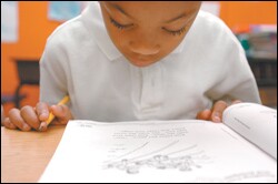 Dominic Spears, 6, takes a test in Jonathan Rojo's 1st grade classroom at George Washington Carver Elementary School in San Francisco last month. The school has received extra resources to help it address the needs of students and teachers.