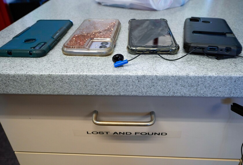 Students' cell phones are collected by school administration before the start of spring break at California City Middle School in California City, Calif., on March 11, 2022.