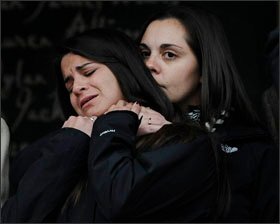 Erica Lafferty, daughter of Sandy Hook Elementary School shooting victim Dawn Hochsprung, right, consoles Carlee Soto, sister of victim Victoria Soto, after victims' families addressed the media on Dec. 9, 2013, in Newtown, Conn. Newtown is not hosting any formal events to mark the one-year anniversary on Saturday.