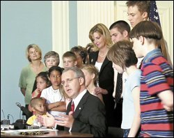 Gov. Brad Henry of Oklahoma prepares to sign legislation that strengthens high school course requirements, during a ceremony at the state Capitol in Oklahoma City on June 7.