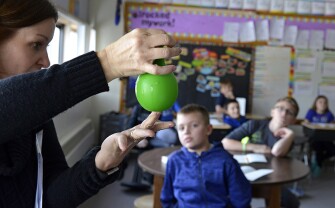 A water-filled balloon is used to demonstrate blood pressure to 4th graders at Washington Elementary School.