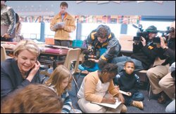 With media surrounding her, Secretary of Education Margaret Spellings, left, sits on the floor with students at Guilford Elementary School in Columbia, Md., last month.