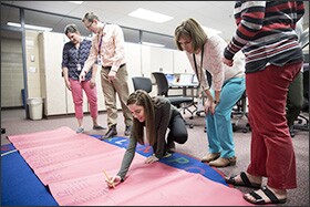 Teachers work together to identify reading levels for each of their students during "genius hour" at Impact Academy at Orchard Lake Elementary in Lakeville, Minn. Impact Academy is a regular public school led by teachers—one of 24 teacher-powered schools in the state.