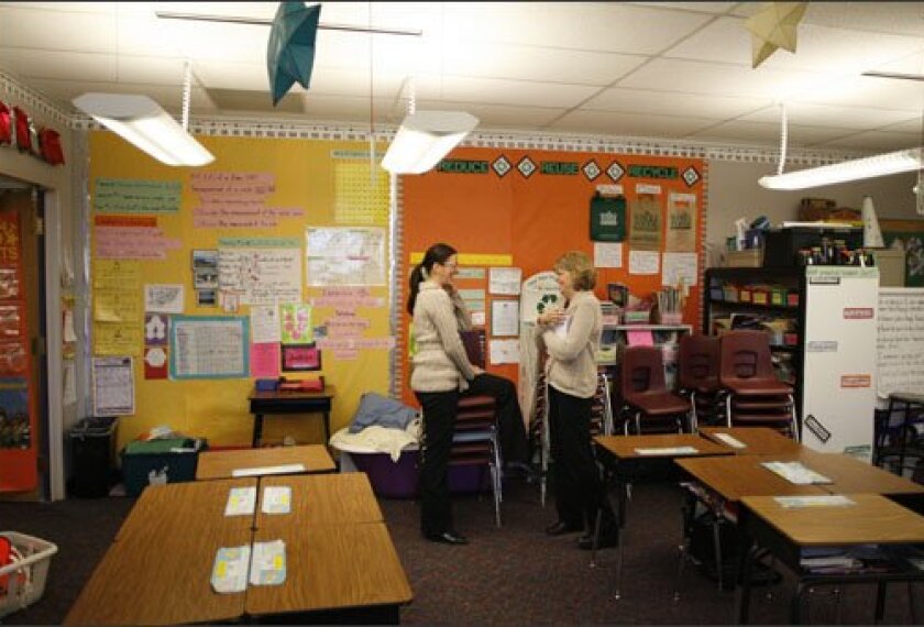 COACHED: Literacy coach Nancy McLean, right, advises Jessica Grojean in the 5th grade teacher’s classroom in the Adams 12 district outside Denver. Districts are putting more emphasis on coaching teachers as a strategy to improve student achievement.