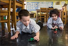 Elijah Cheverez, left, and Adam Elkara, both 5, play with wooden trains during “choice time” at the Earth School in New York City on Nov. 21. For the last 45 minutes of the school day, kindergartners engage in unstructured play activities of their own choosing.
