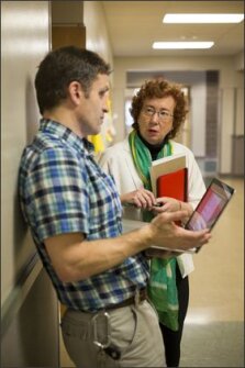 Summit High Principal Alice DeWittie and science teacher Jason Colquhoun conduct walk-throughs of classrooms to evaluate how teachers and students are using technology, and then they discuss their observations outside the classrooms.