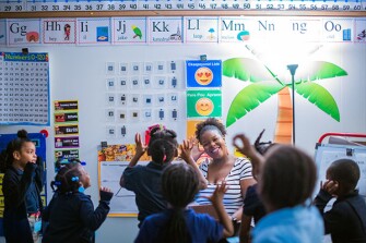 Kindergarten teacher Priscilla Joseph works with students beginning their second year enrolled in the Toussaint L’Ouverture Academy, a Haitian Creole dual-language program at Mattahunt Elementary School in Boston.