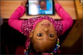 Erie'Onna Seaster, 3, and other children at the Crescent Early Learning Center in Pittsburgh's Homewood neighborhood use an app-based activity to support "high-quality talk" among children, parents, and teachers.