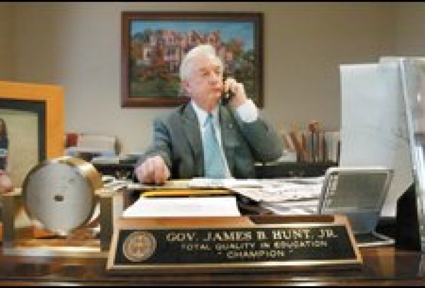 Former Gov. James B. Hunt Jr. of North Carolina works at his law office in Raleigh. The nameplate on his desk is a reminder of his efforts to rally political and public support for a new system of school accountability.
