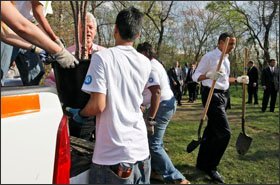 Former President Bill Clinton and President Barack Obama work with volunteers as they prepare to plant trees during a national-service project at Kenilworth Aquatic Gardens in Washington last week. Mr. Obama signed legislation that creates more opportunities for students and others to serve their communities.