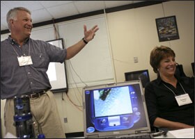 A lesson on the misconceptions within genetics and natural selection elicits laughter from both the presenter, Jeffrey Osborn, a biology professor at the University of Kentucky, and Ramona C. Jayner, an assistant principal at Corbin Middle School in Kentucky, during a workshop in Clinton, Tenn.