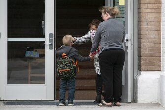 Principal and District Superintendent Bonnie Lower takes the temperature of a student at Willow Creek School as the school reopened, Thursday, May 7, 2020, in Willow Creek, Mont.