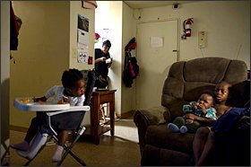 Above, Kourtney Mills peers out from her kitchen to check on her children, from left to right, Emily Bakker, Blake Bakker, and Nathan Mills. Ms. Mills spent five years on a waiting list for a spot in Potomac Gardens, a public housing complex in Washington.