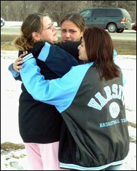Red Lake High School students, from left, Sondra Hegstrom, Marla Hegstrom, and Ashley Morrison weep together following a deadly shooting rampage, Monday, March 21, 2005, at their school in Red Lake, Minn.
