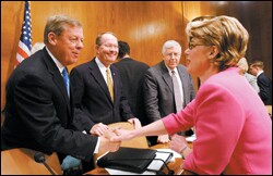 Margaret Spellings greets Sen. Johnny Isakson, R-Ga., as Sen. Lamar Alexander, R-Tenn., second from left, and Sen. Michael B. Enzi, R-Wyo., look on after her confirmation hearing.