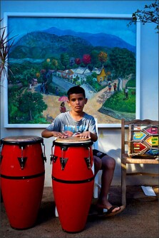 A young Dominican boy named Eduardo practices drums at the home of the artist Ricardo Toribio in Santiago de Los Caballeros in the Dominican Republic.