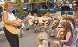 Aynor Elementary School music teacher Connie Christy learned to play guitar through a program offered by the nonprofit organization Guitars in the Classroom, then taught 23 of her coworkers how to use the instrument as a classroom tool.