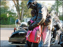 4th grader Lea Alston hugs her stepfather, Tim Knight, as he drops her off at the school.