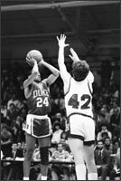 Duke University's Johnny Dawkins, left, shoots despite the defensive efforts of Harvard University's Arne Duncan, during their 1984 basketball game at Harvard, in Cambridge, Mass.