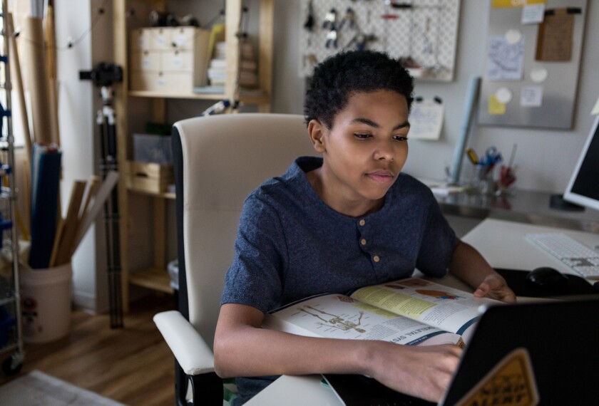 time for homework African American boy studies for science test from home