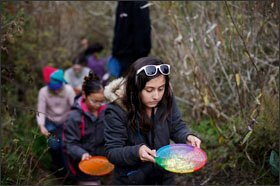 Andrea Garcia-Milla, a 6th grader at Terman Middle School, brings back a water sample from a pond during a week at NatureBridge in Sausalito, Calif. The National Park Service is expanding its education programming.