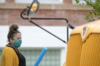 A Willow Creek School teacher welcomes students back to class as the school reopened amid the COVID-19 pandemic, Thursday, May 7, 2020, in Willow Creek, Mont.