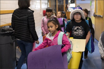 Yania Gonzalez, 7, carries her mat to yoga club at Doull Elementary School in Denver. The school offers after-school yoga three days a week—twice a week as a replacement for detention and once a week as a club for students who want to participate. The school’s use of yoga is part of its larger efforts to meet the social and emotional needs of students.