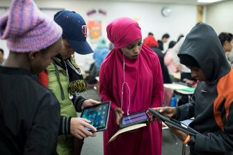 Students in an English literacy for newcomers class work together on a class presentation at Como Park High School in St. Paul, Minn. For more than 30 percent of the students in the district, English is not their first language.