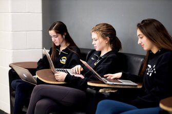 Left to right, Delia Stiles, 16, Madeline Campbell, 17, and Jodi Siegel, 16, sit in language and composition class at Pascack Valley Regional High.