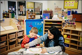 Wheaton High senior Diana Romero works with a preschooler at the nearby career-and-technical education center. Course-taking patterns are marked by race and socioeconomic class at the CTE center and Wheaton North.