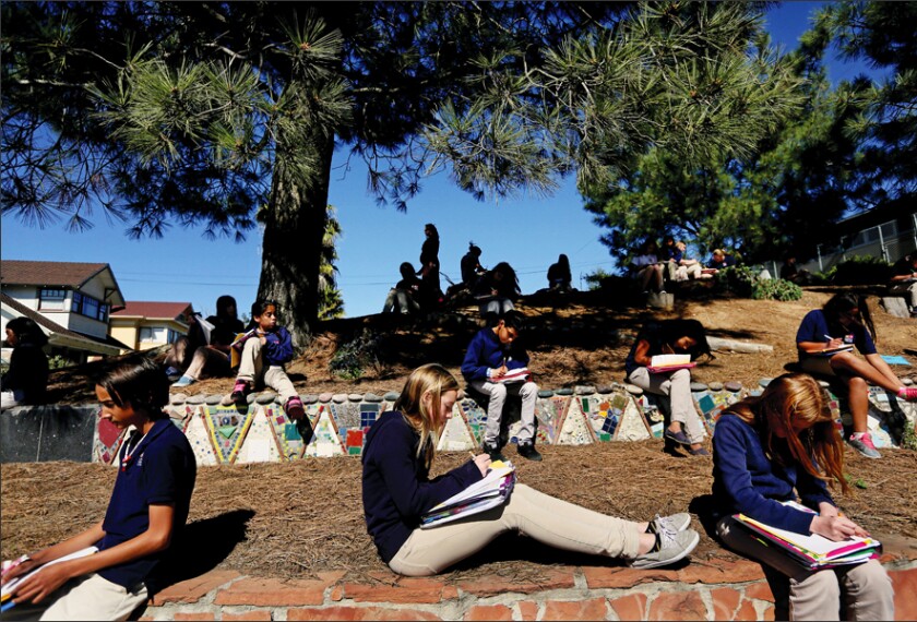 Students in Monica Farren’s 6th grade English class read outside during a poetry exercise at Albert Einstein Academy Charter Middle School in San Diego.