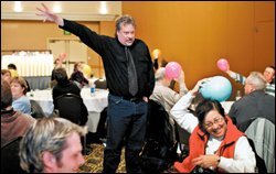 Bill Robertson uses ballons to demonstrate a lesson in electricity